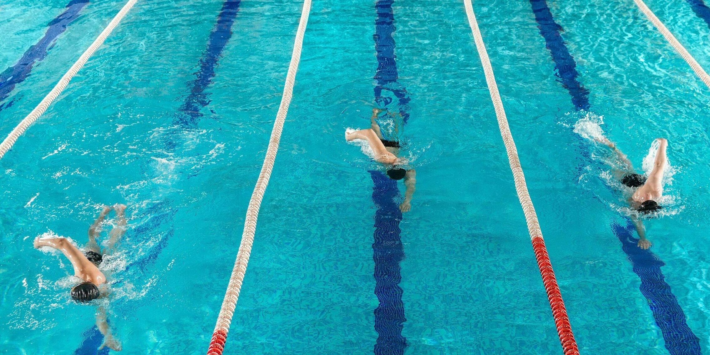 three-male-swimmers-racing-against-each-other