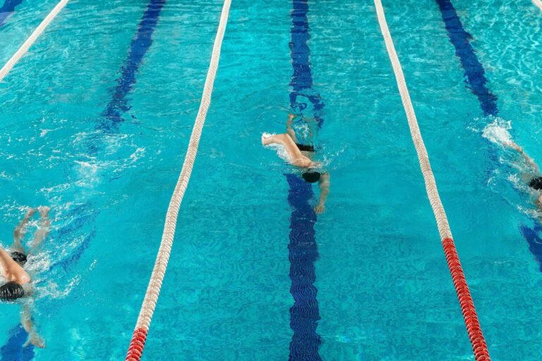 three-male-swimmers-racing-against-each-other